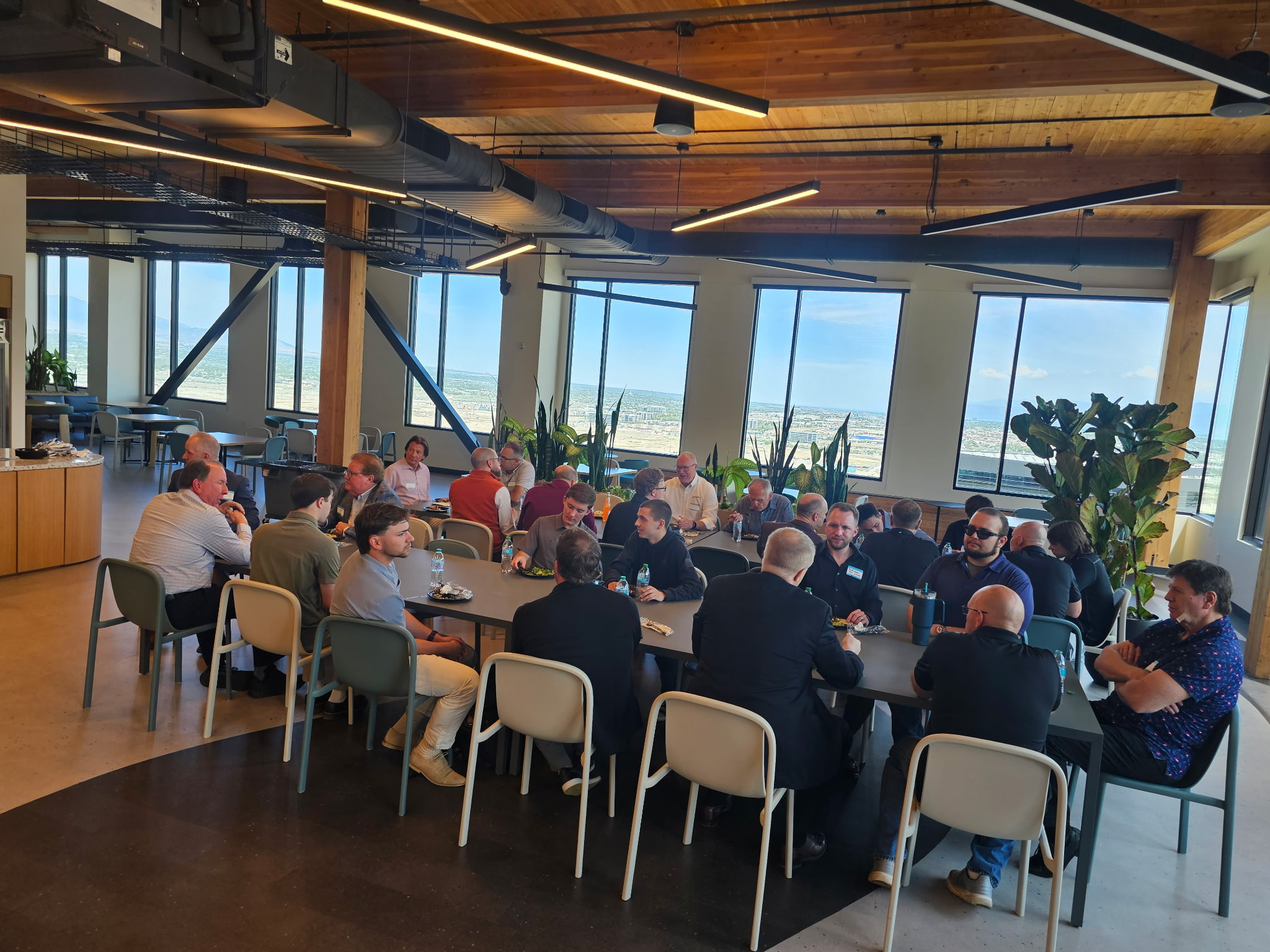 Attendees seated around tables during the networking lunch