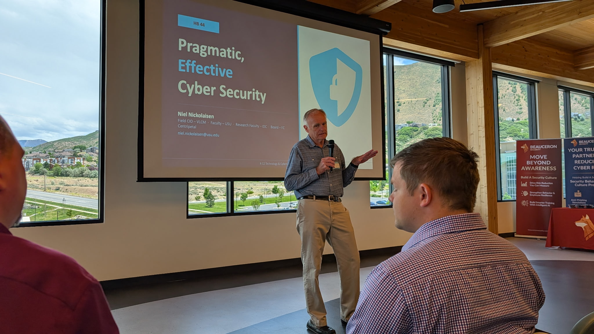 Niel Nickolaisen presents a slide titled Pragmatic, Effective Cyber Security